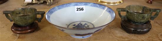 A Chinese blue and white bowl and a pair of green stone cups, wood stands etc